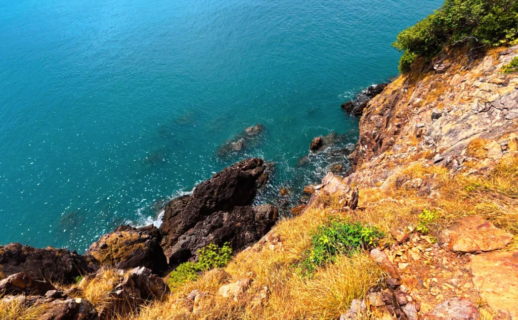 Peering over the cliff at Cape Tukata on Koh Mak, Trat Province