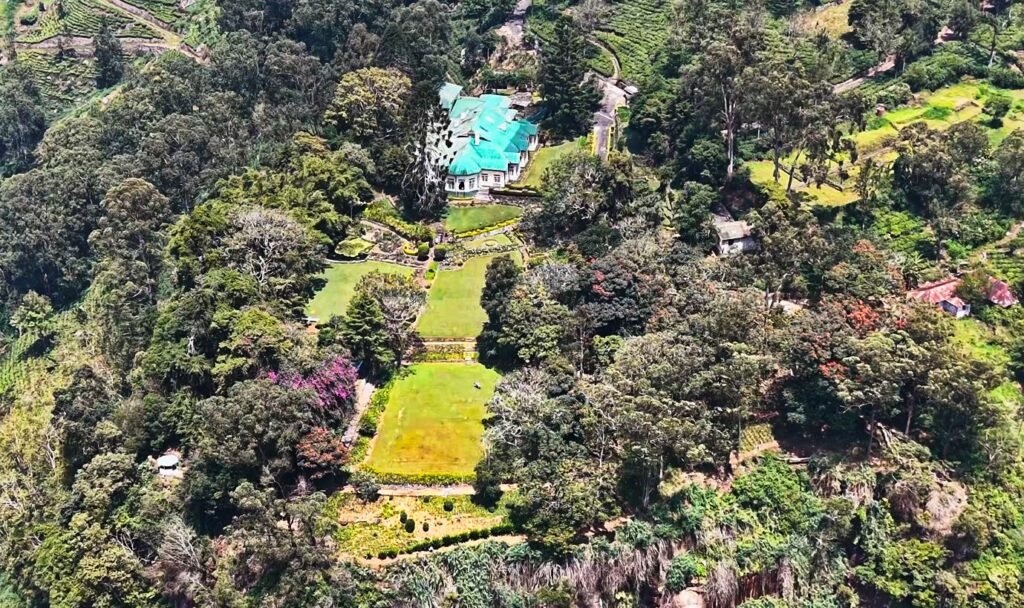 Drone view of Sir Thomas Lipton's former bungalow on the Dambatenne estate, the valley and tea estates stretching into the haze below.